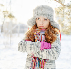 Winter portrait of young woman in fur hat