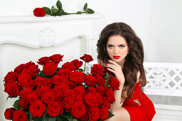 Attractive beautiful woman with red bouquet of roses. Fashion el