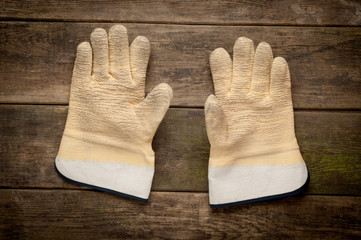 Pair work gloves lying on planks of wood