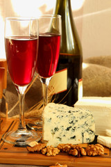 Two glasses of red wine and cheese.