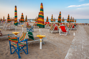 Summer beach landscape with umbrellas and beach chairs