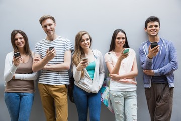 Students using their smartphones in a row