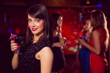 Pretty brunette drinking a cocktail
