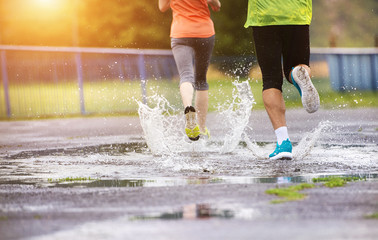 Couple running in rainy weather