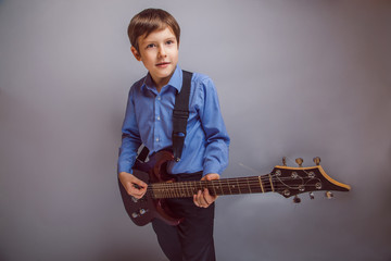 teenager boy brown hair of European appearance playing guitar ex