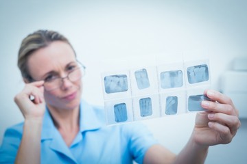 Female dentist looking at x-ray