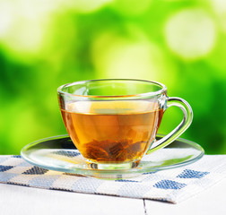 Cup of tea on nature background