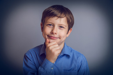 teenager boy 10 years of European appearance thinks smiling d