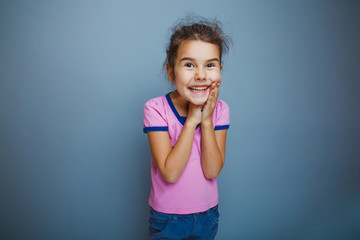 the girl child is happy surprise on gray background
