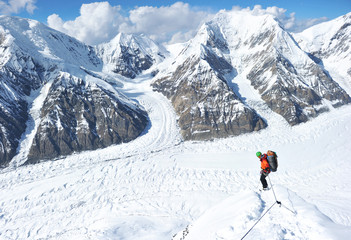 Naklejka na ściany i meble Climber on the snowy mountains