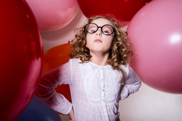Portrait of serious teen girl on the background of large rubber