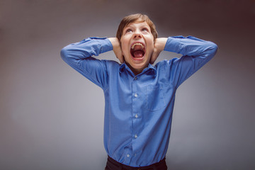 boy teenager of European appearance brown hair closed his ears s