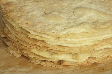 Freshly baked homemade shortcakes for cake on wooden board.