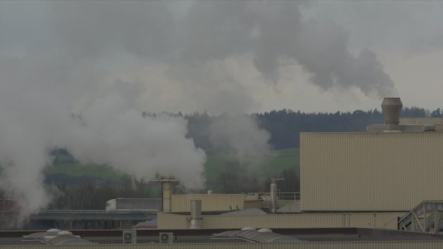 Chemical factory with smoke stack, air pollution