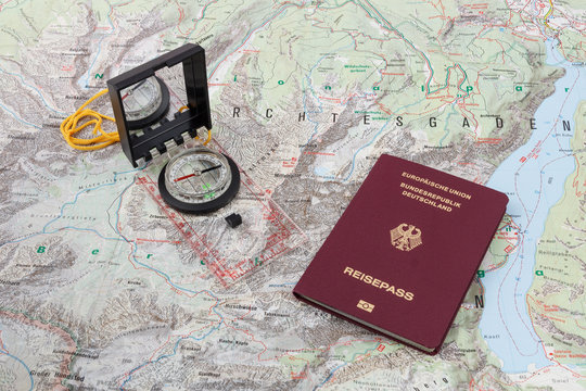 Compass and passport on a hiking map of the Berchtesgaden Alps