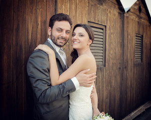 Married couple near wooden cabins