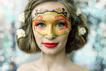 Young woman in a carnival mask