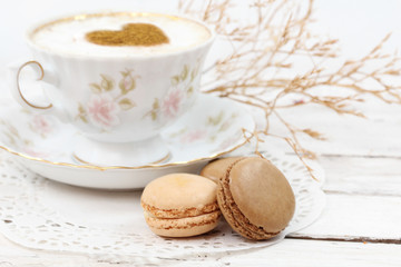 Macaroons traditional Parisian cookie with cup of coffee
