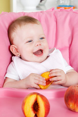 Happy little girl eating fruit