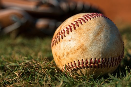 Baseball and Glove on Field