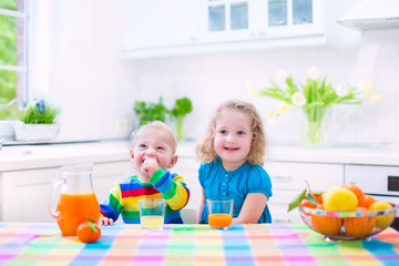 Kids drinking orange juice