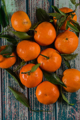 Natural sweet clementines on rustic table from above