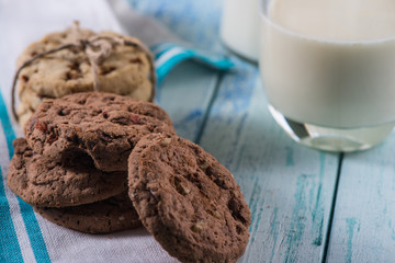 brown and white cookies with glass of fresh milk