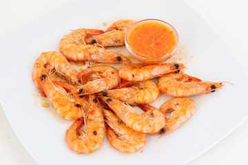 shrimps with sauce on the white plate