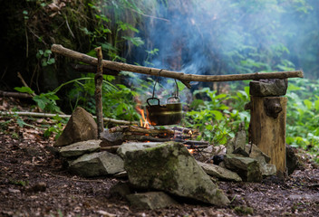 Camping kettle over burning campfire