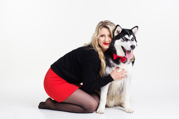 Young girl with her husky dog isolated on white