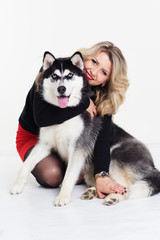 Young girl with her husky dog isolated on white