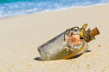 A bottle with a message, which made the sea on the sand of a tro