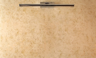 Lamp on beige wall background