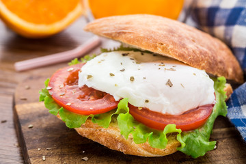 Burger with pouched egg and tomato