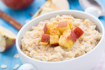 Tasty oatmeal with apples and cinnamon
