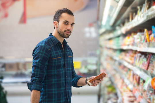 Handsome Young Man Shopping In A Grocery Supermarket