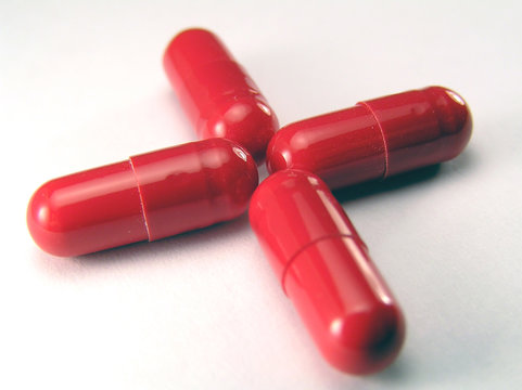 Red pills arranged in shape of a cross
