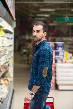 Handsome Young Man Shopping In A Grocery Supermarket