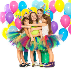 Group of joyful little kids having fun at birthday party