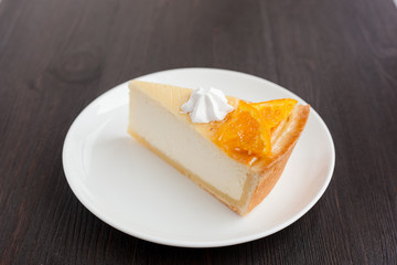 Cheesecake Dessert decorated with oranges and meringue