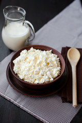 Delicious homemade cottage cheese with milk on the table