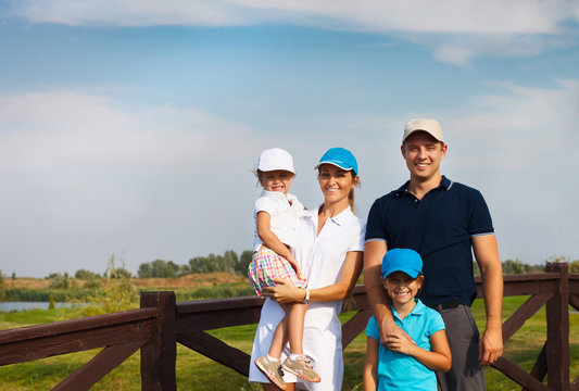 Happy young family in golf country club