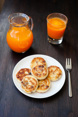 Delicious homemade cheese pancakes with fresh carrot juice