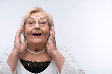 Portrait of lovely grandmother surprised