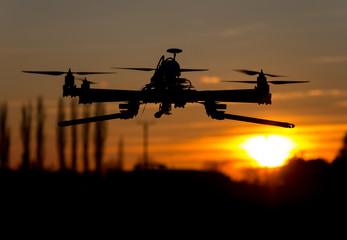 Hexacopter drone flying in the sunset
