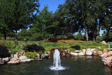 Fototapeta na wymiar Fountain In A Pond At Botanical Gardens