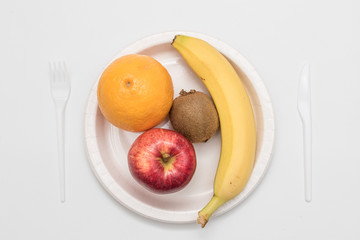 Sweet fresh fruits on plate isolated on white 
