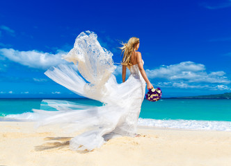 Fototapeta na wymiar beautiful blond fiancee in white wedding dress with big long whi