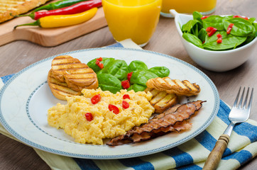 Scrambled eggs with toast and fresh salad