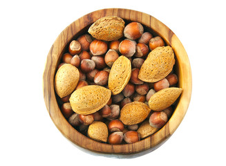 Top view of almonds and nuts in a handmade wooden bowl isolated